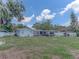 Spacious backyard featuring an outdoor kitchen and mature trees at 1195 S 1St Ave, Bartow, FL 33830