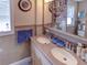 Bathroom featuring a dual sink vanity and a built-in medicine cabinet for ample storage at 1195 S 1St Ave, Bartow, FL 33830