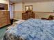 Spacious bedroom with cozy seating area, warm carpet, and a large dresser at 1195 S 1St Ave, Bartow, FL 33830