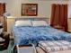 Comfortable bedroom with a plush blue comforter, warm colors, and ambient lighting at 1195 S 1St Ave, Bartow, FL 33830