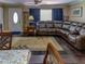Open-concept living space with a leather sofa and hardwood floors adjacent to the dining area at 1195 S 1St Ave, Bartow, FL 33830
