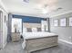 Comfortable bedroom with a queen-size bed, gray walls, and neutral-colored carpet at 1424 Fleur Dr, Davenport, FL 33837