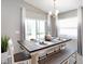 Dining room with a dark wood table, bench seating, and ample natural light from large windows at 1424 Fleur Dr, Davenport, FL 33837
