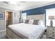 Comfortable main bedroom with a queen bed, natural light, and ensuite bathroom at 1424 Fleur Dr, Davenport, FL 33837