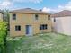 A view of the home's backyard with a grassy area at 143 Alfani St, Davenport, FL 33896