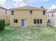 A view of the home's backyard with a grassy area at 143 Alfani St, Davenport, FL 33896