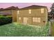 Backyard of home featuring a green lawn, sliding glass door to the home's interior at 143 Alfani St, Davenport, FL 33896