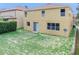A view of the home's backyard with a grassy area at 143 Alfani St, Davenport, FL 33896