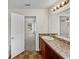 Bathroom featuring a wooden vanity with granite counter and open doorway to bedroom at 143 Alfani St, Davenport, FL 33896