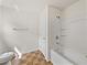 Bright bathroom featuring a shower-tub combo with tile flooring and white walls at 143 Alfani St, Davenport, FL 33896