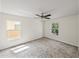 Bright bedroom with ceiling fan, plush carpeting, and view to outside at 143 Alfani St, Davenport, FL 33896