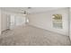 Large bedroom with neutral paint, carpeted floors, a ceiling fan, and plenty of natural light at 143 Alfani St, Davenport, FL 33896