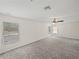 Upstairs bonus room with windows and ceiling fan at 143 Alfani St, Davenport, FL 33896