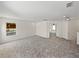 Large bonus room with neutral carpet leading to doorway and staircase at 143 Alfani St, Davenport, FL 33896