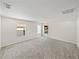 Spacious bonus room with neutral carpeting, recessed lighting, and multiple windows at 143 Alfani St, Davenport, FL 33896