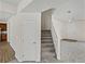 Foyer with staircase leading to upper level and wood flooring, as well as coat closet at 143 Alfani St, Davenport, FL 33896