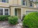 Charming front entrance with green door, stone accents, and well-maintained landscaping at 143 Alfani St, Davenport, FL 33896