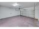 Spacious garage with a roll-up door, overhead lighting, and concrete floors at 143 Alfani St, Davenport, FL 33896
