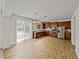 Modern kitchen with wood cabinets, stainless steel appliances and bright sliding glass doors at 143 Alfani St, Davenport, FL 33896