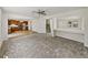 Open-concept living area with carpeted floors, adjacent to a kitchen with wood cabinets at 143 Alfani St, Davenport, FL 33896
