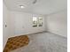Bright, carpeted living room with natural light and space for furniture at 143 Alfani St, Davenport, FL 33896