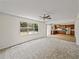 Bright living room flows into the kitchen with wood cabinets, stainless steel appliances at 143 Alfani St, Davenport, FL 33896
