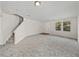 Spacious living room with neutral carpet and staircase, offering ample open space at 143 Alfani St, Davenport, FL 33896