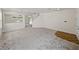 Spacious carpeted living room featuring ample natural light and staircase to upper level at 143 Alfani St, Davenport, FL 33896