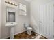 Compact powder room features a pedestal sink, window, and tiled flooring at 143 Alfani St, Davenport, FL 33896