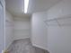 Spacious walk-in closet with ample shelving and neutral carpeting at 143 Alfani St, Davenport, FL 33896