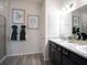 Modern bathroom with dual sinks, stylish fixtures, and decorative wall art at 1444 Fleur Dr, Davenport, FL 33837