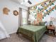 bedroom featuring a unique tree-themed wall design and neutral decor at 1444 Fleur Dr, Davenport, FL 33837