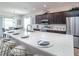 Modern kitchen with sleek countertops, stainless steel appliances, and ample cabinet space for storage at 1444 Fleur Dr, Davenport, FL 33837