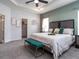 Comfortable main bedroom featuring a tray ceiling, soft carpet, and access to a spacious walk-in closet at 1444 Fleur Dr, Davenport, FL 33837
