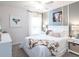 Well-lit bedroom with cute decor, large windows, and plush carpet at 1448 Fleur Dr, Davenport, FL 33837