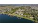 Aerial image displaying lakefront homes with private docks and scenic water views in a tranquil setting at 148 Melissa Trl, Auburndale, FL 33823
