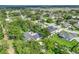 An aerial view showing home surrounded by mature trees and well-maintained lawns in a suburban setting at 148 Melissa Trl, Auburndale, FL 33823