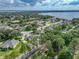 Beautiful aerial view of a home surrounded by lush landscaping and mature trees near a scenic lake at 148 Melissa Trl, Auburndale, FL 33823