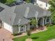 Aerial view of a well-maintained home featuring a brick driveway, mature landscaping, and a classic architectural style at 148 Melissa Trl, Auburndale, FL 33823