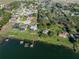 Aerial view of waterfront homes with boat docks offering direct access to the lake, surrounded by greenery at 148 Melissa Trl, Auburndale, FL 33823