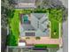 Aerial view of a beautifully landscaped home with a pool and solar panels on the roof at 148 Melissa Trl, Auburndale, FL 33823