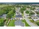 Captured from above, a home nestled among lush trees and manicured lawns in a tranquil neighborhood setting at 148 Melissa Trl, Auburndale, FL 33823