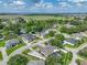 An aerial view showcases a single-Gathering home with a manicured lawn surrounded by lush trees and neighborhood residences at 148 Melissa Trl, Auburndale, FL 33823
