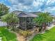 Aerial view of lush backyard with pool and rock waterfall under screened enclosure at 148 Melissa Trl, Auburndale, FL 33823