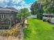 An expansive backyard features a screened pool, waterfall, and manicured lawn at 148 Melissa Trl, Auburndale, FL 33823