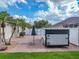 Backyard brick paved parking area with trailer and palm trees on a sunny day with cloudy skies at 148 Melissa Trl, Auburndale, FL 33823