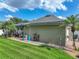 Landscaped backyard showcasing a screened pool, lush green lawn, and palm trees for a private outdoor oasis at 148 Melissa Trl, Auburndale, FL 33823