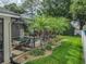 A tropical backyard oasis featuring a pool, waterfall, and lush landscaping at 148 Melissa Trl, Auburndale, FL 33823
