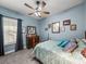 Bedroom featuring a ceiling fan, light blue walls, a mirror, and a four-post bed at 148 Melissa Trl, Auburndale, FL 33823