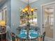 Dining area features an ornate table with seating for four, a chandelier, and a pool view at 148 Melissa Trl, Auburndale, FL 33823